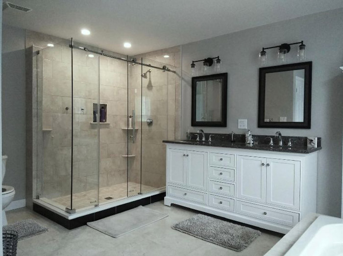 a bathroom with a glass shower and sink